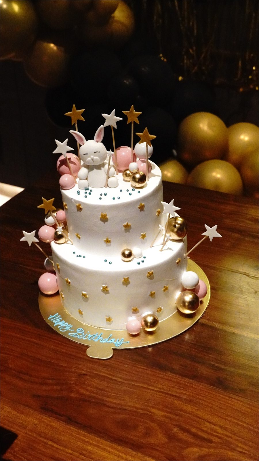 Two-tier rabbit-themed birthday cake prepared for a celebration